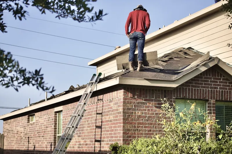 Professional roofer working on a residential roof in Tequesta